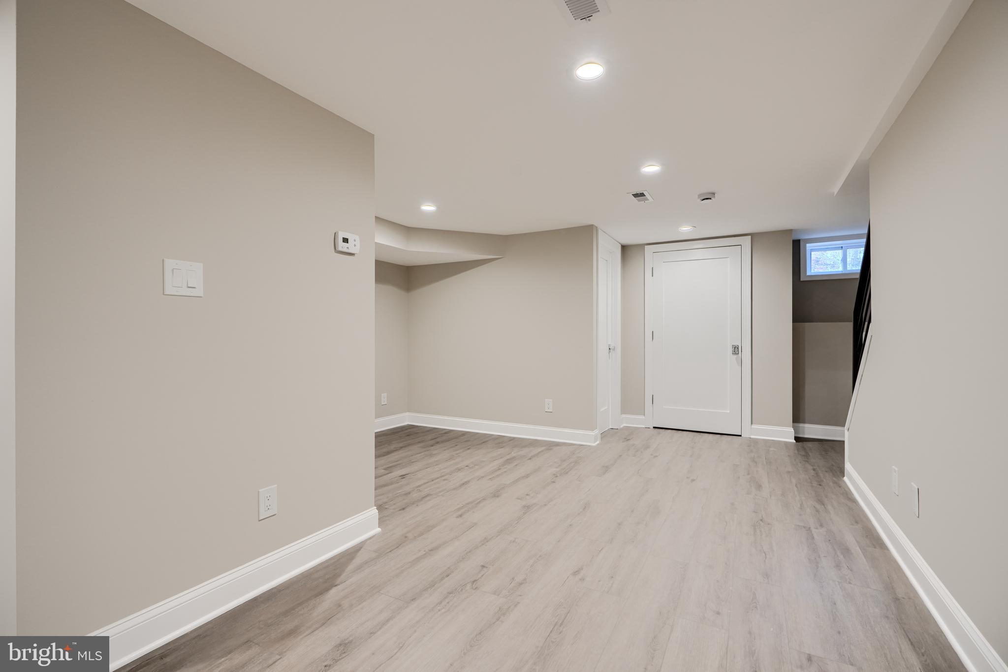 621 Ponca Street Baltimore, MD 21224 - Photo 16 of 38 a view of an empty room with wooden floor