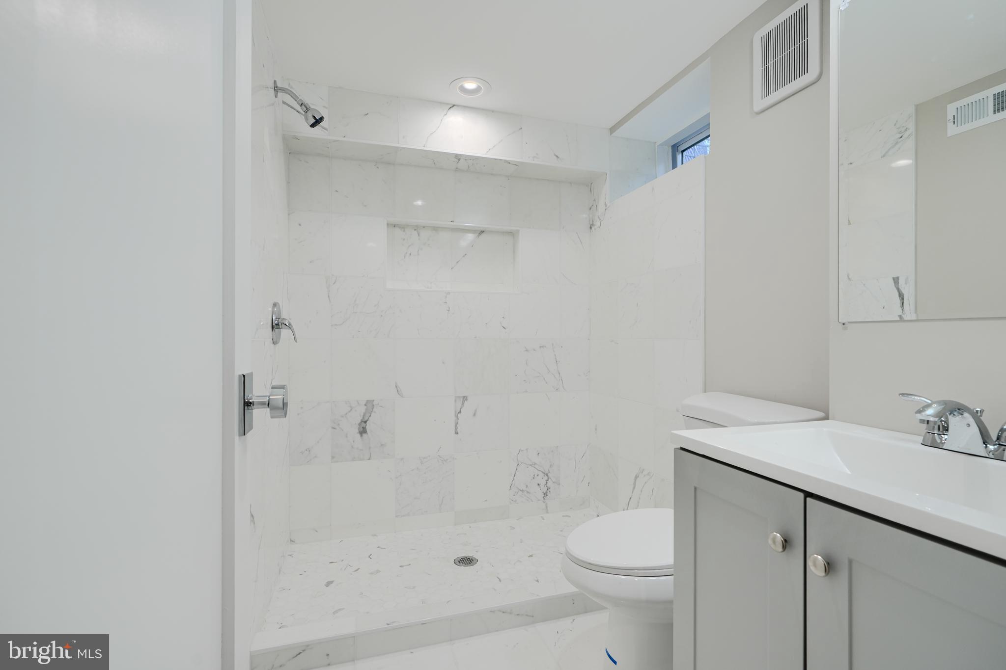 621 Ponca Street Baltimore, MD 21224 - Photo 18 of 38 a bathroom with a sink toilet and shower