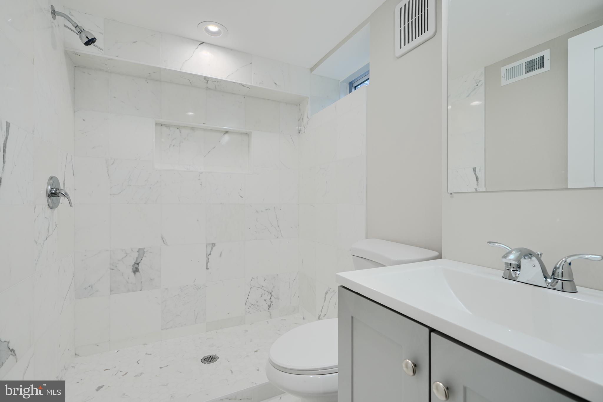 621 Ponca Street Baltimore, MD 21224 - Photo 19 of 38 a bathroom with a sink toilet and shower