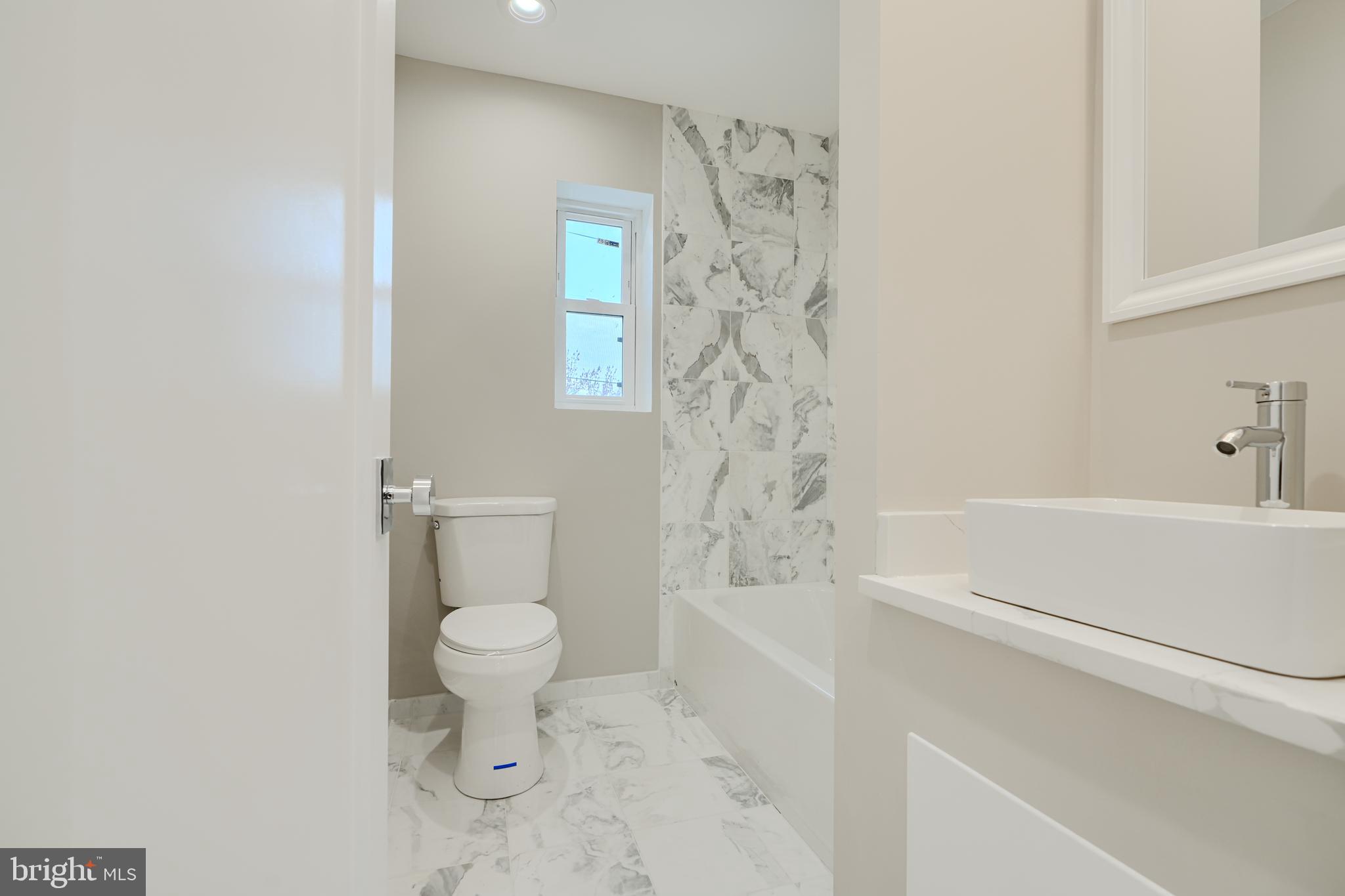 621 Ponca Street Baltimore, MD 21224 - Photo 25 of 38 a bathroom with a toilet and a bathtub