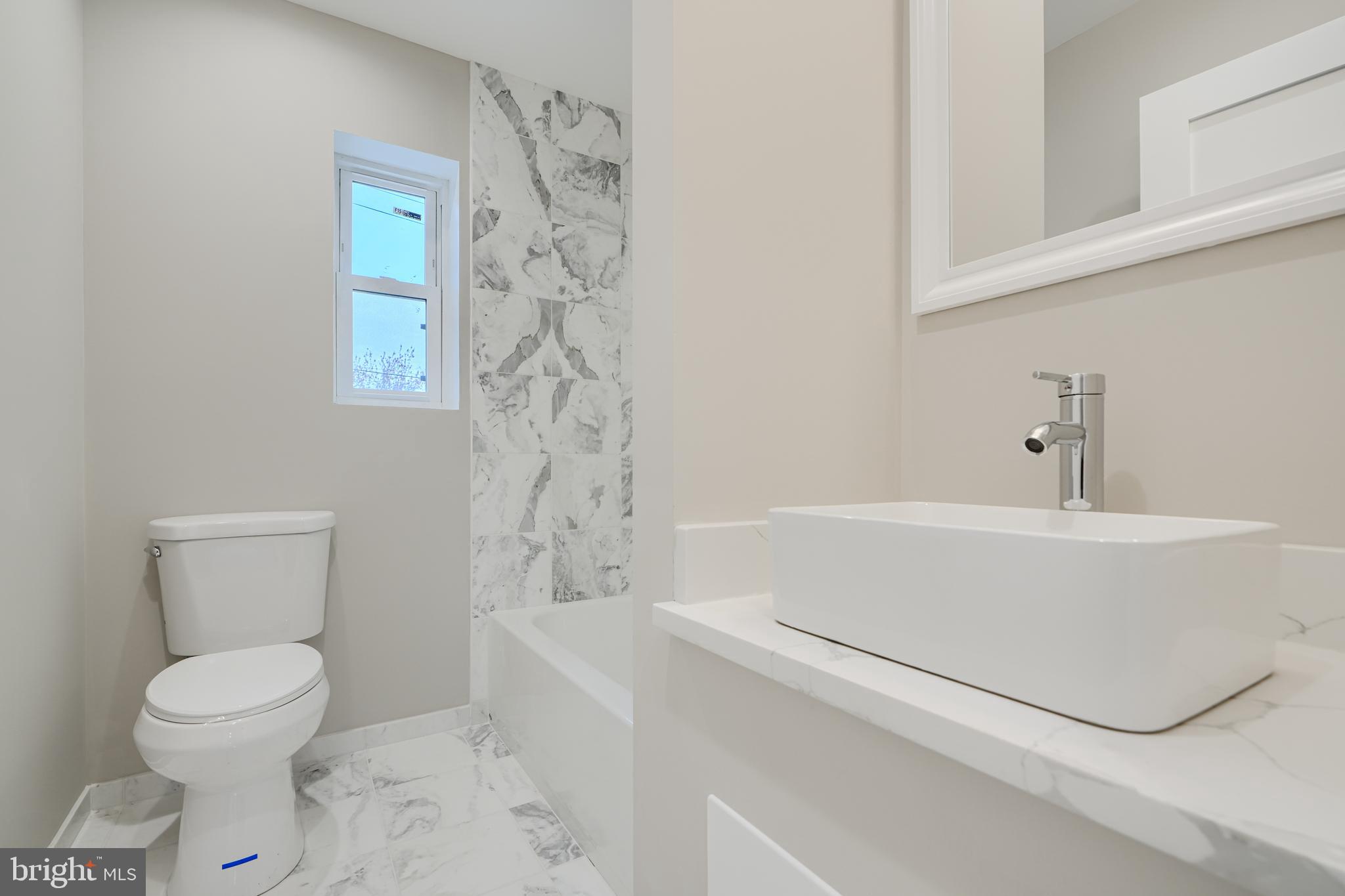 621 Ponca Street Baltimore, MD 21224 - Photo 27 of 38 a bathroom with a bathtub and toilet