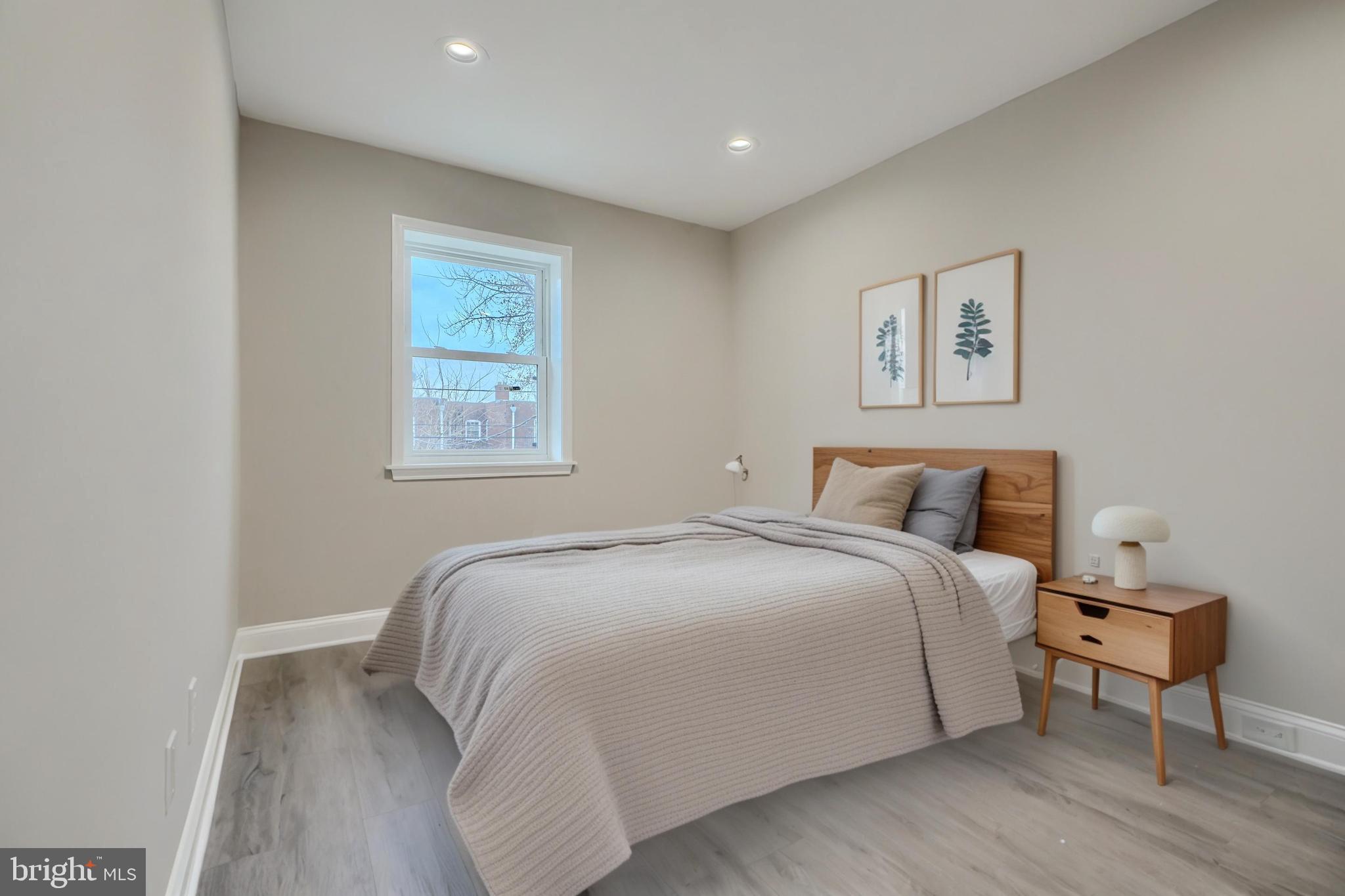 621 Ponca Street Baltimore, MD 21224 - Photo 28 of 38 a bedroom with a bed and a lamp on table