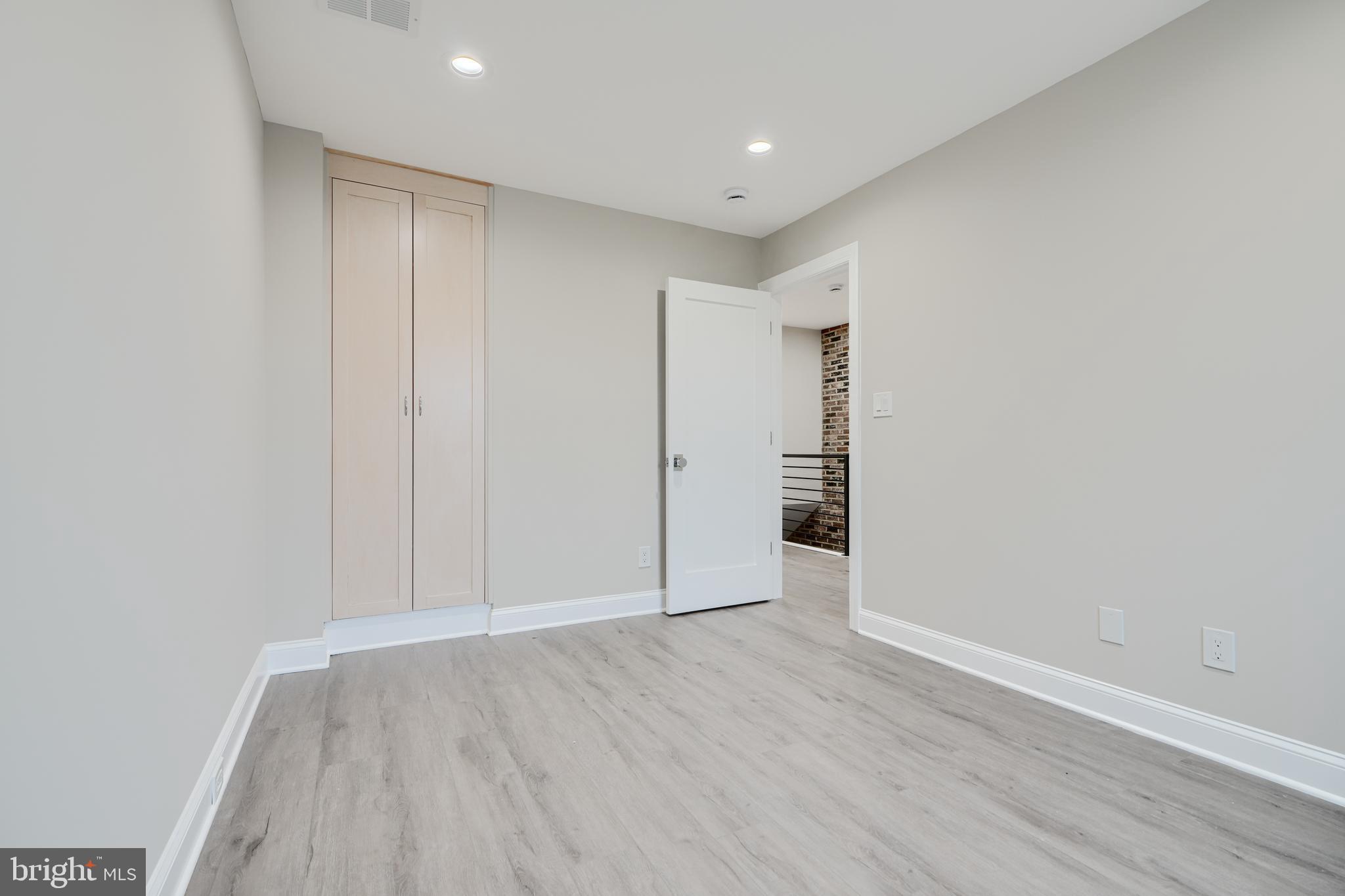 621 Ponca Street Baltimore, MD 21224 - Photo 29 of 38 a view of an empty room with wooden floor