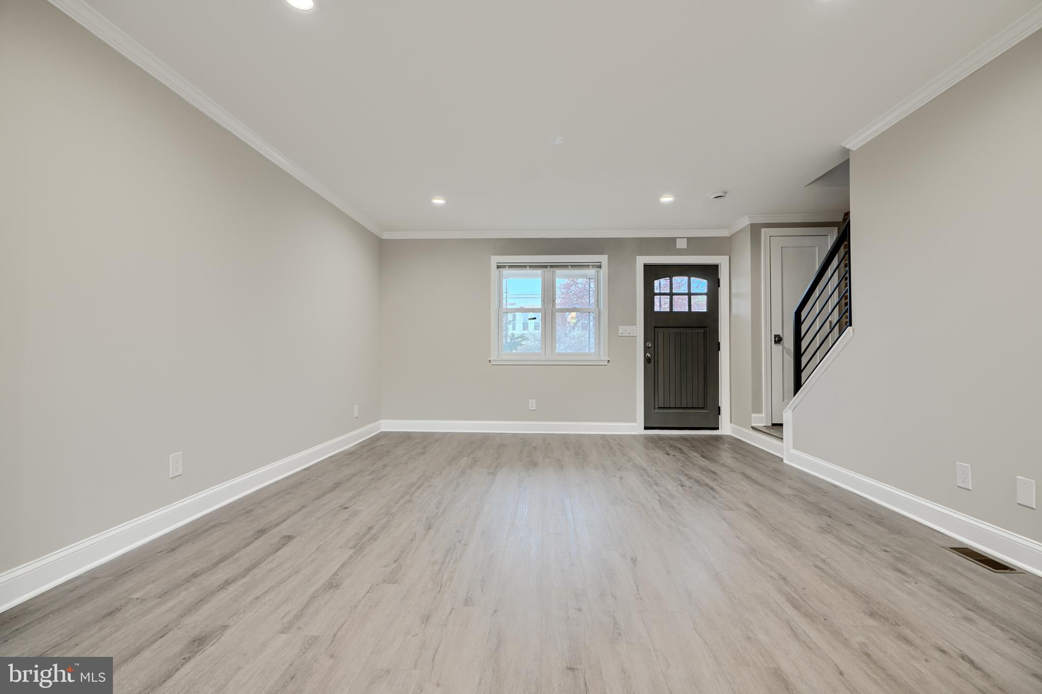 621 Ponca Street Baltimore, MD 21224 - Photo 3 of 38 wooden floor in an empty room with a window