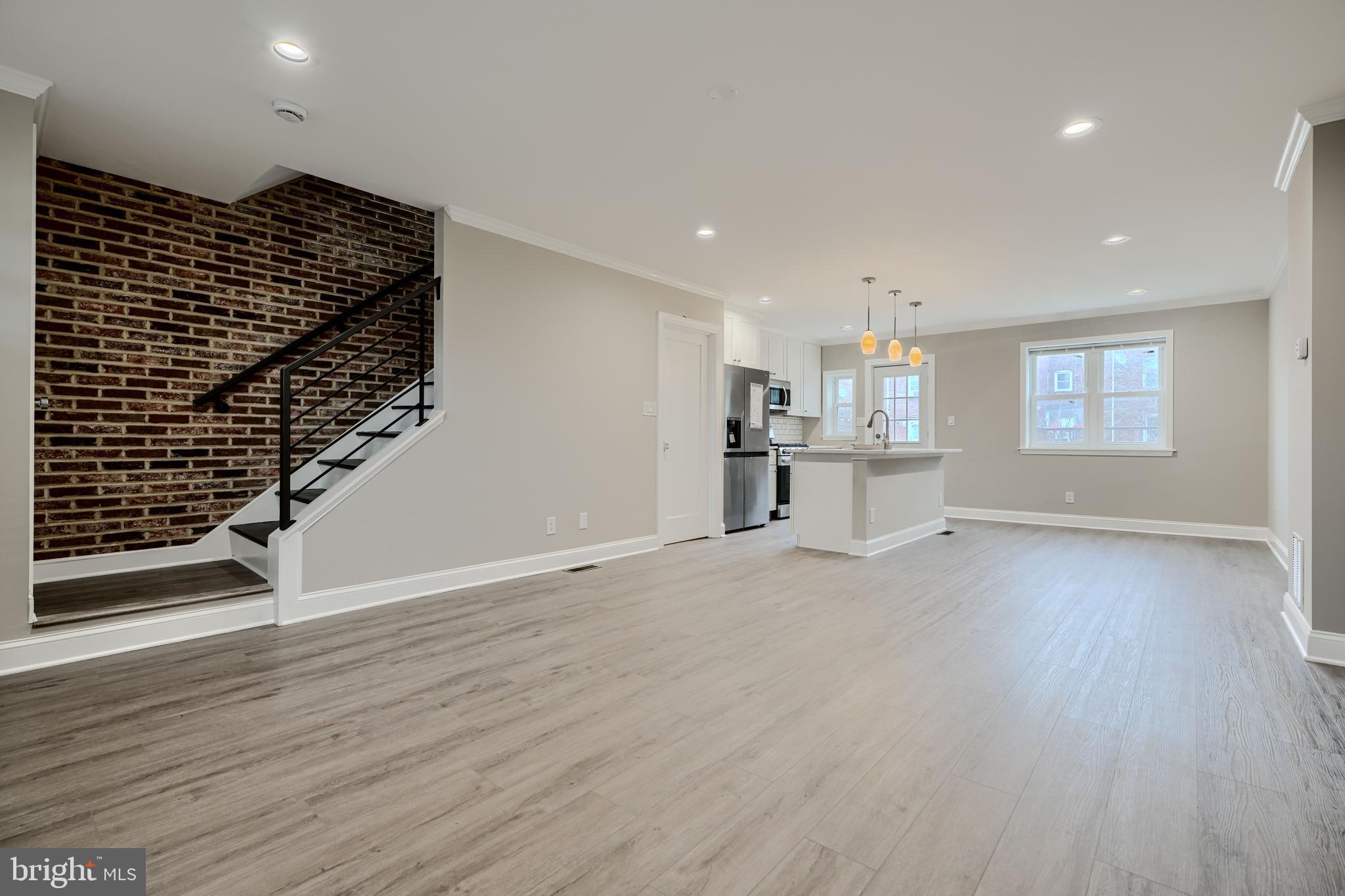 621 Ponca Street Baltimore, MD 21224 - Photo 4 of 38 an empty room with wooden floor and windows