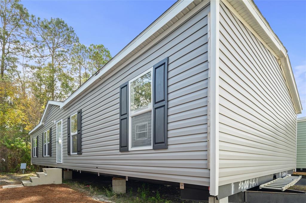 3417 Carter Road Haines City, FL 33844 - Photo 1 of 1 a view of a white house with a large window and stairs