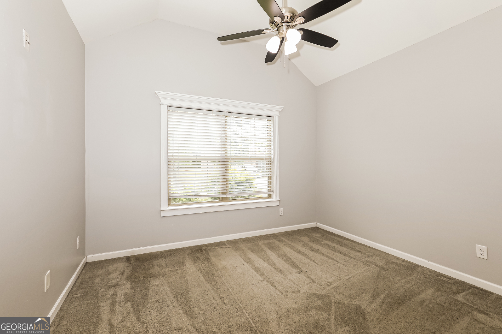 3216 Alhambra Circle Hampton, GA 30228 - Photo 15 of 21 an empty room with a window and a fan
