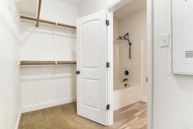 an empty room with windows and closet