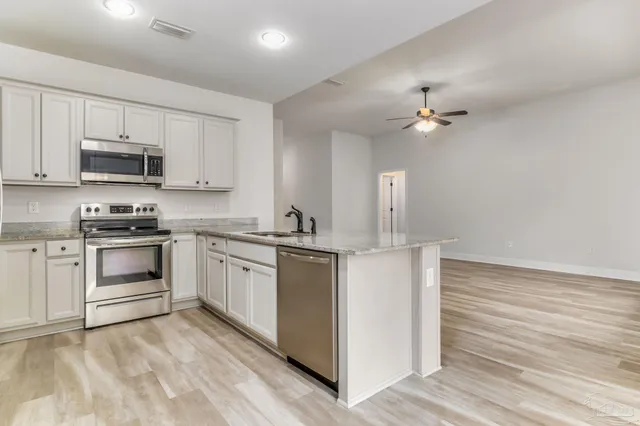 a utility room with cabinets washer and dryer