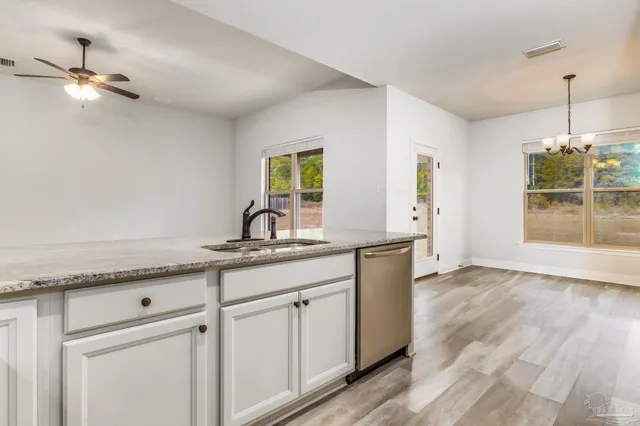 an empty room with a ceiling fan and a window
