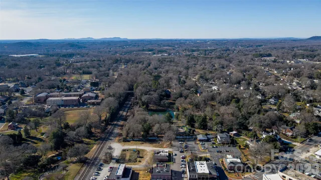 an aerial view of house with yard and mountain view in back