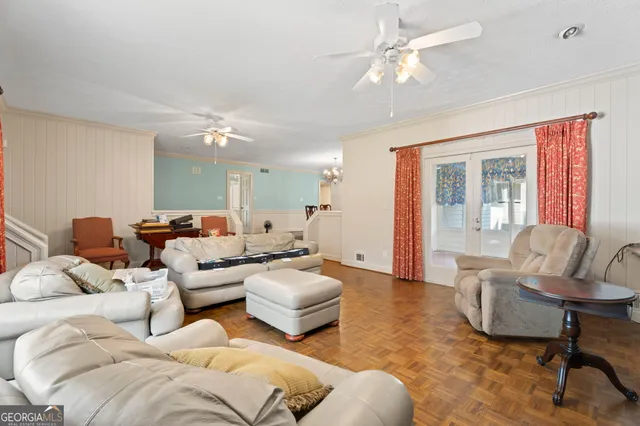 a view of a dining room with furniture and chandelier