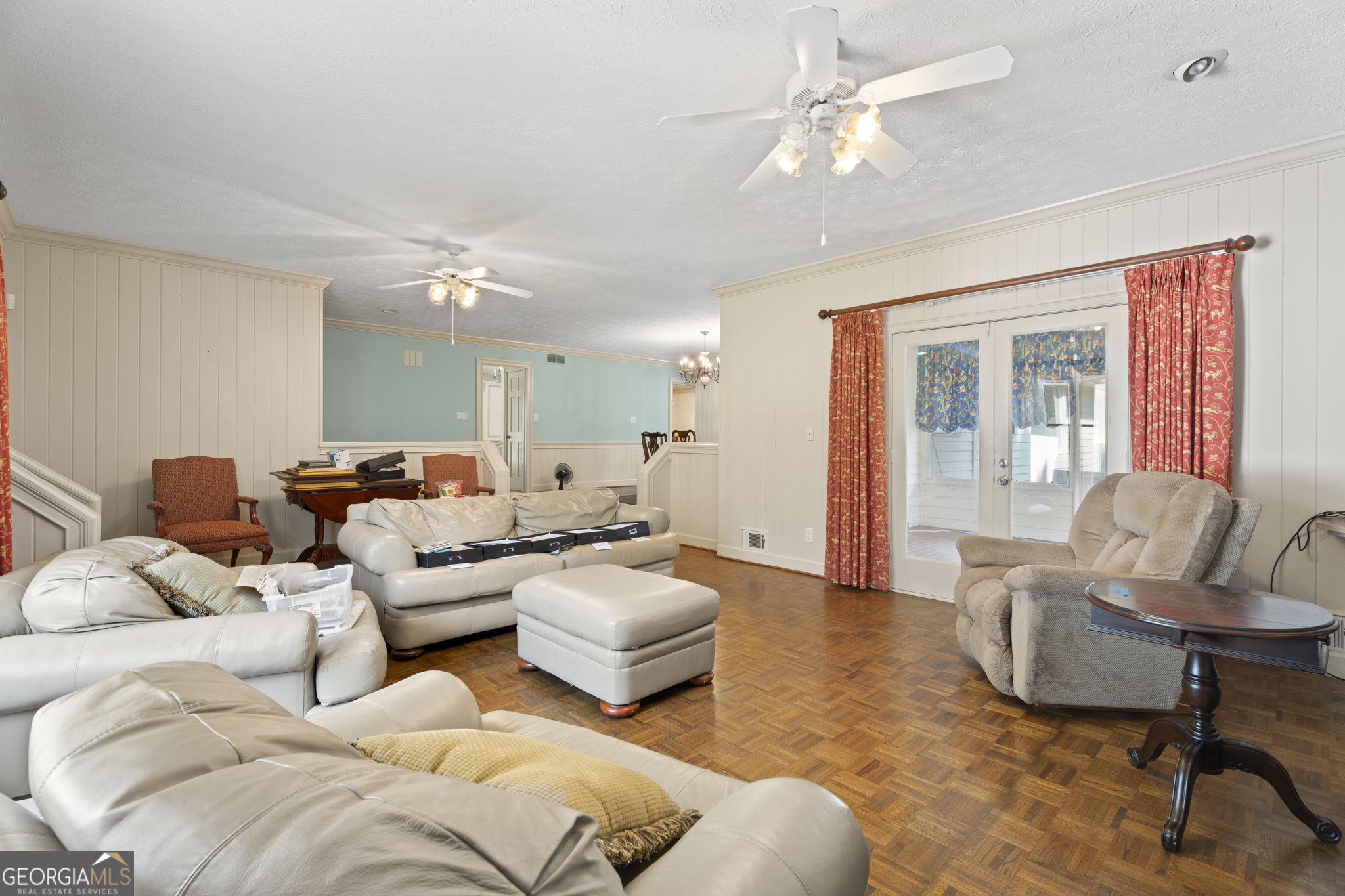 1080 Conyers Road McDonough, GA 30252 - Photo 11 of 55 a living room with furniture and a chandelier