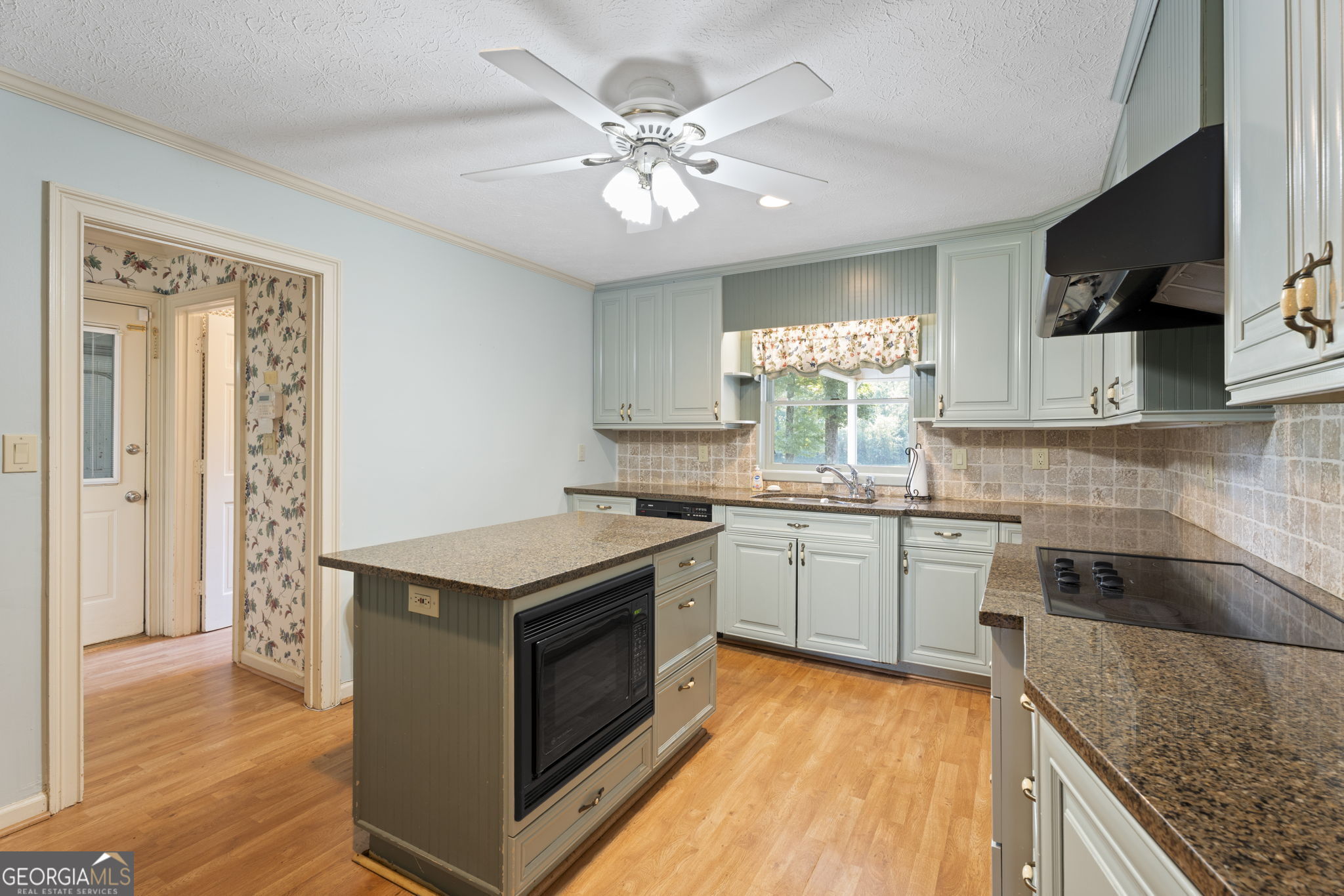 1080 Conyers Road McDonough, GA 30252 - Photo 15 of 55 a kitchen with a stove window and cabinets