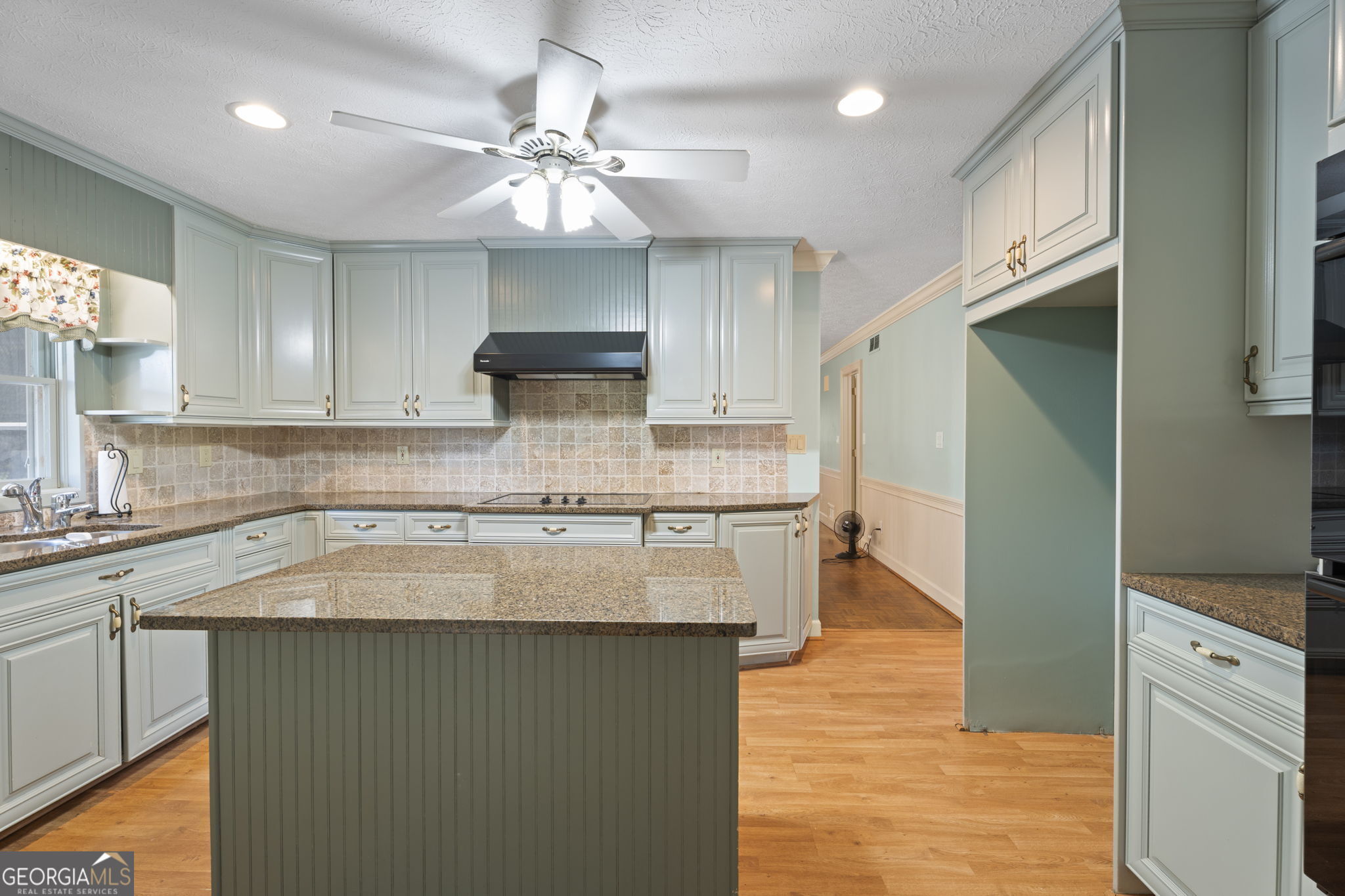 1080 Conyers Road McDonough, GA 30252 - Photo 16 of 55 a kitchen with kitchen island granite countertop a sink cabinets and stainless steel appliances