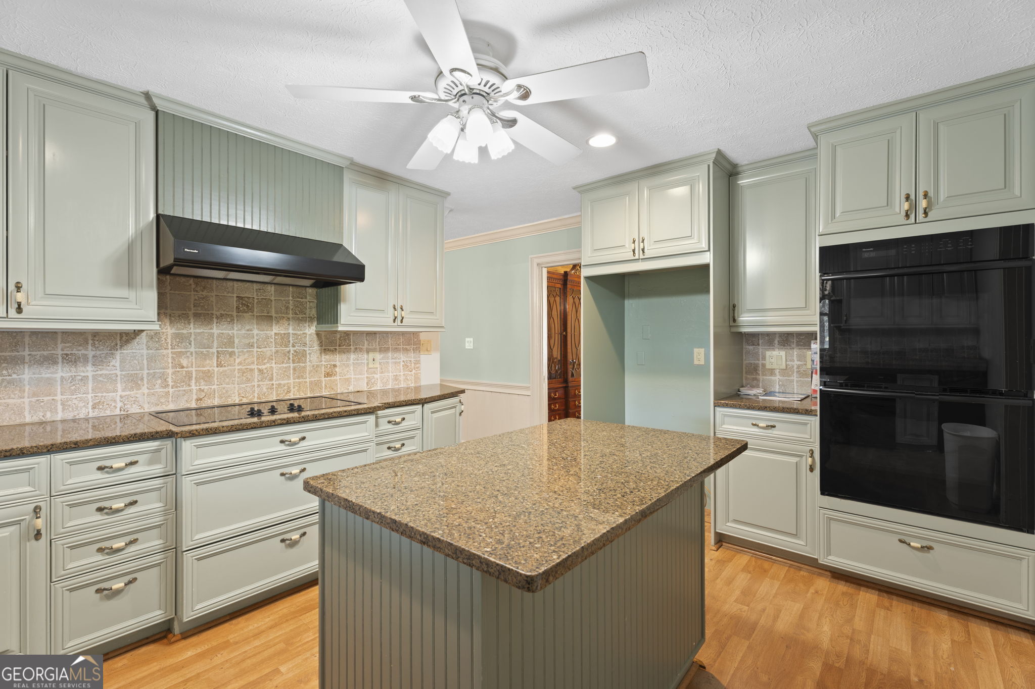 1080 Conyers Road McDonough, GA 30252 - Photo 17 of 55 a kitchen with granite countertop stainless steel appliances a stove refrigerator and cabinets