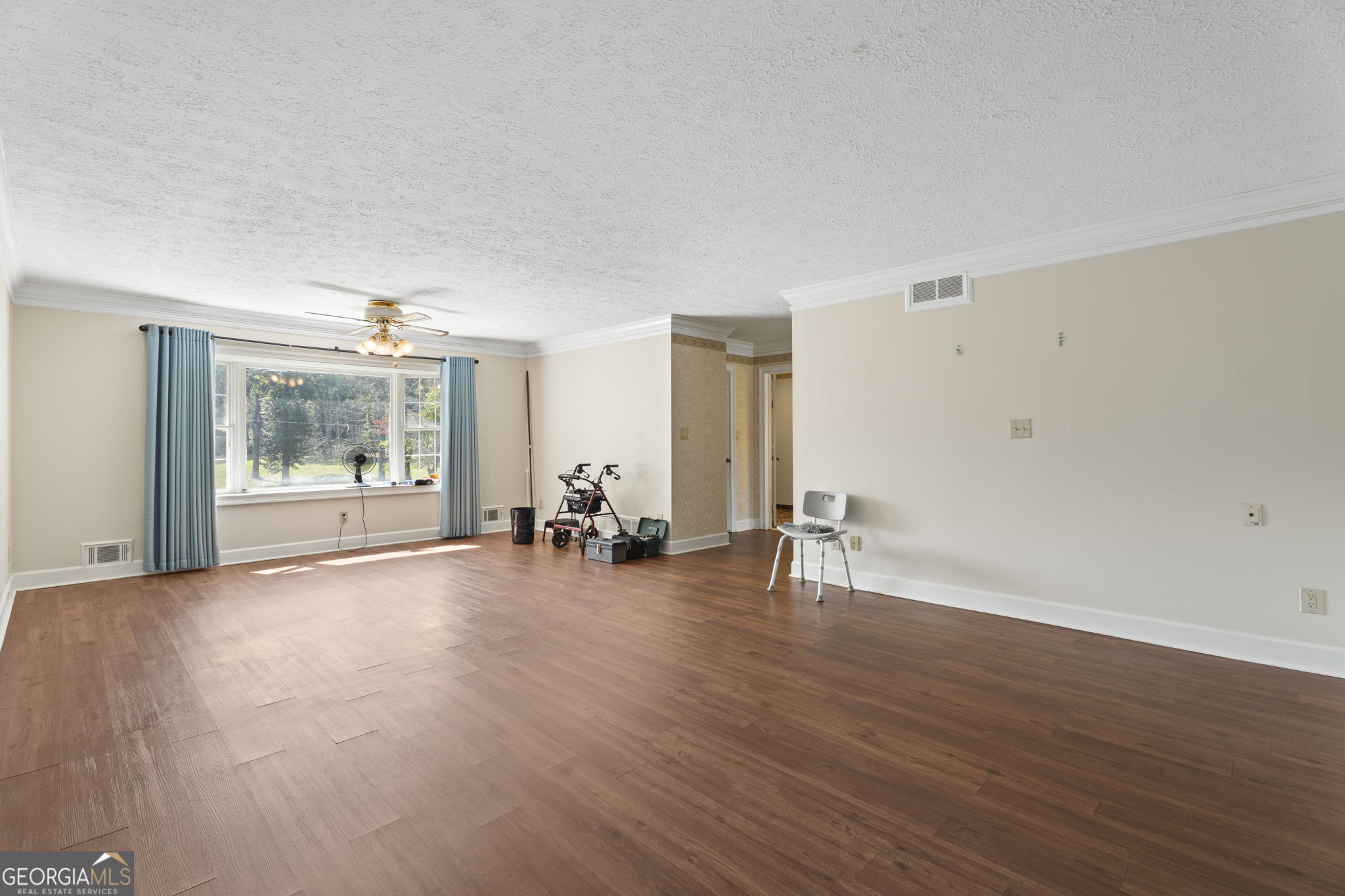 1080 Conyers Road McDonough, GA 30252 - Photo 21 of 55 an empty room with wooden floor and windows