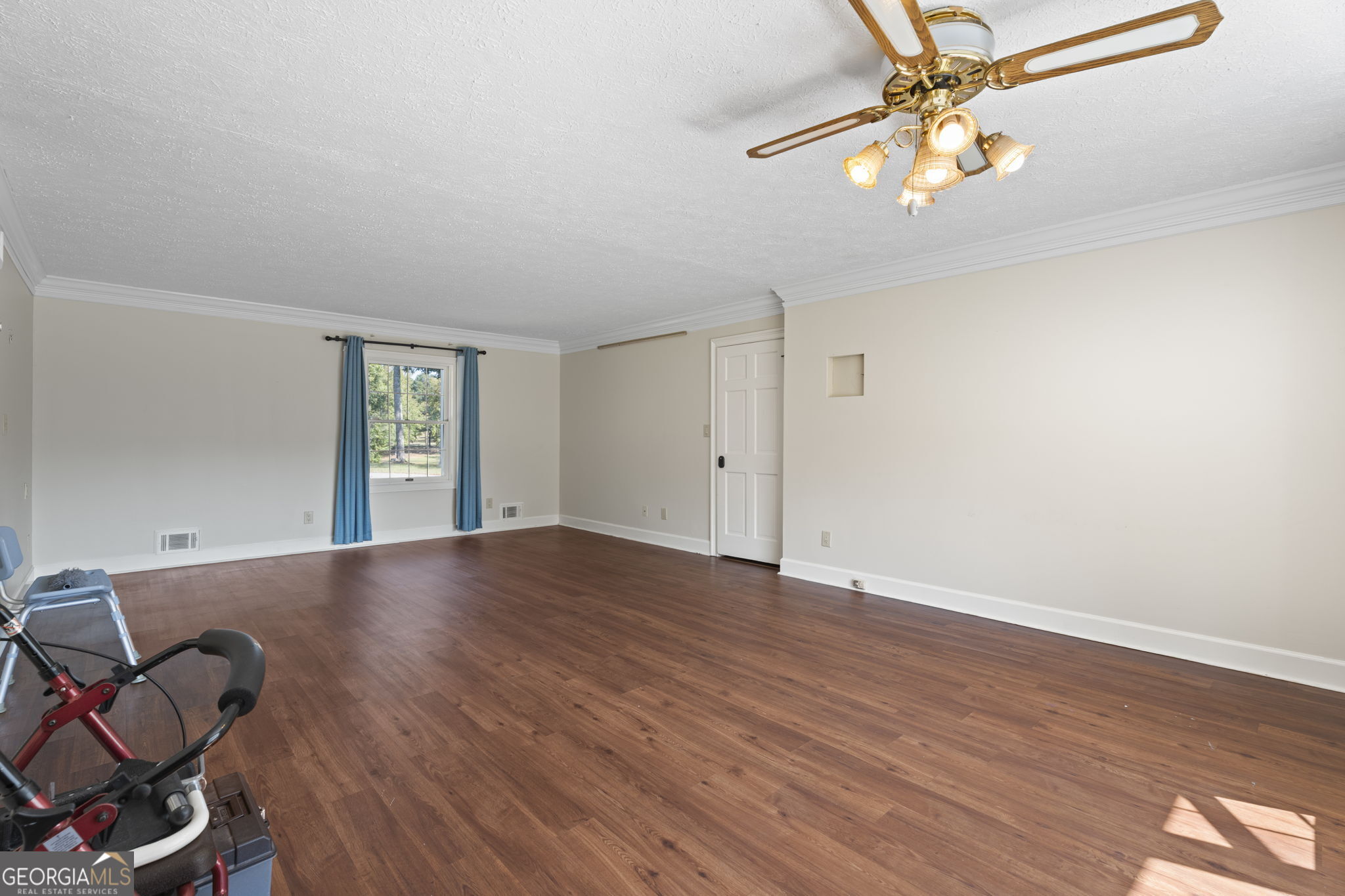 1080 Conyers Road McDonough, GA 30252 - Photo 22 of 55 an empty room with wooden floor fan and windows