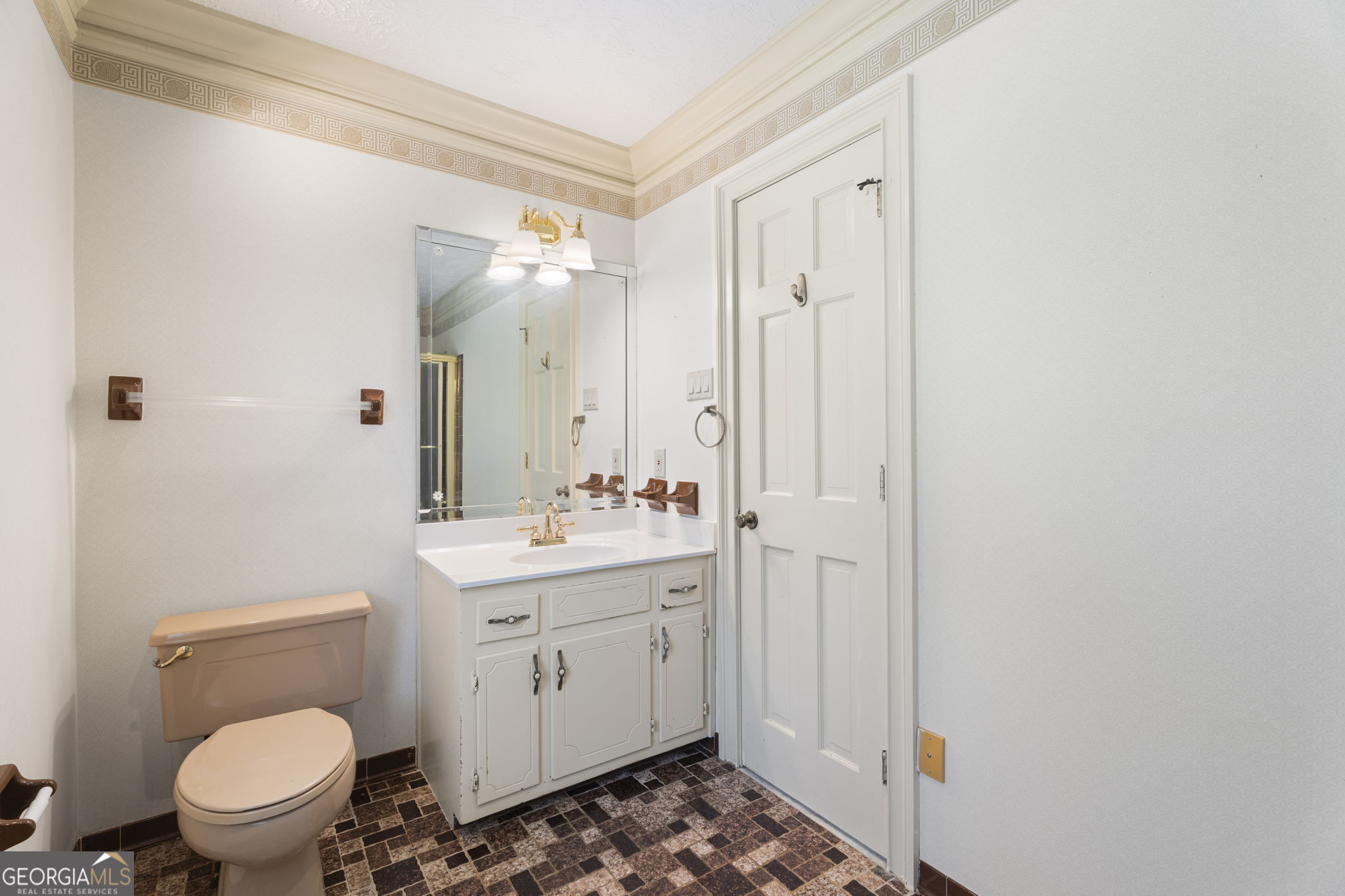 1080 Conyers Road McDonough, GA 30252 - Photo 25 of 55 a bathroom with a toilet a sink and a mirror