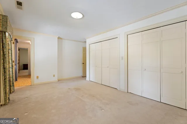 a bed room with a bed and a chair