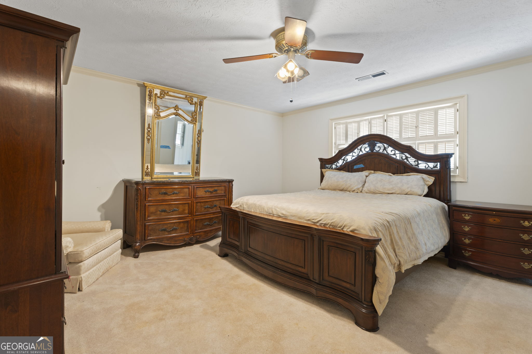 1080 Conyers Road McDonough, GA 30252 - Photo 36 of 55 a bedroom with a bed and dresser with mirror