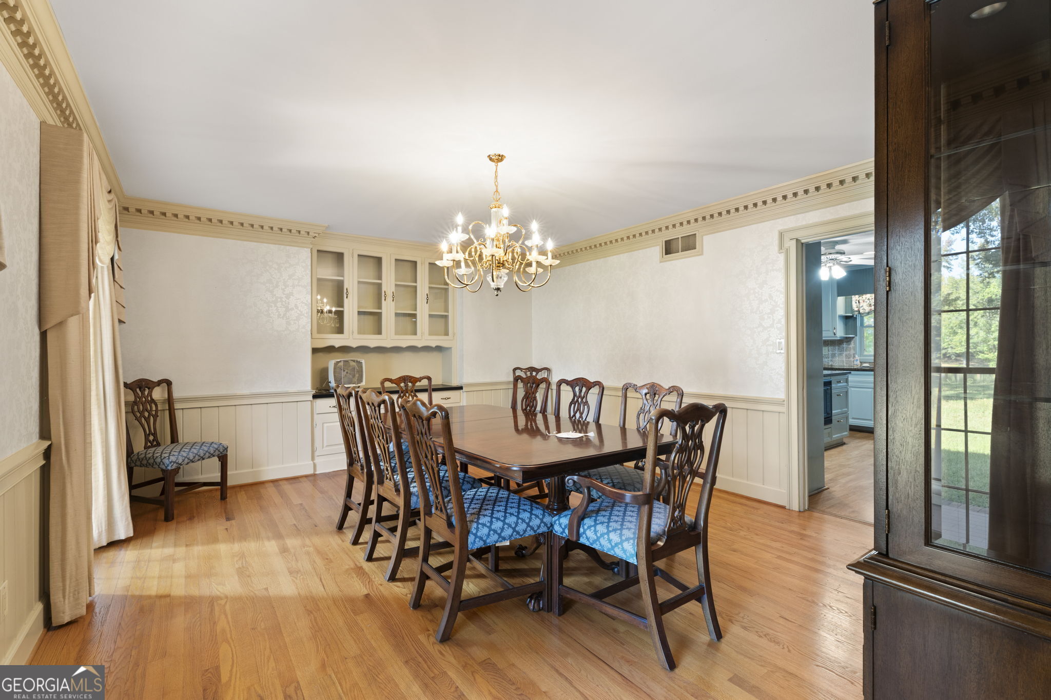 1080 Conyers Road McDonough, GA 30252 - Photo 7 of 55 a dining room with furniture a chandelier and wooden floor