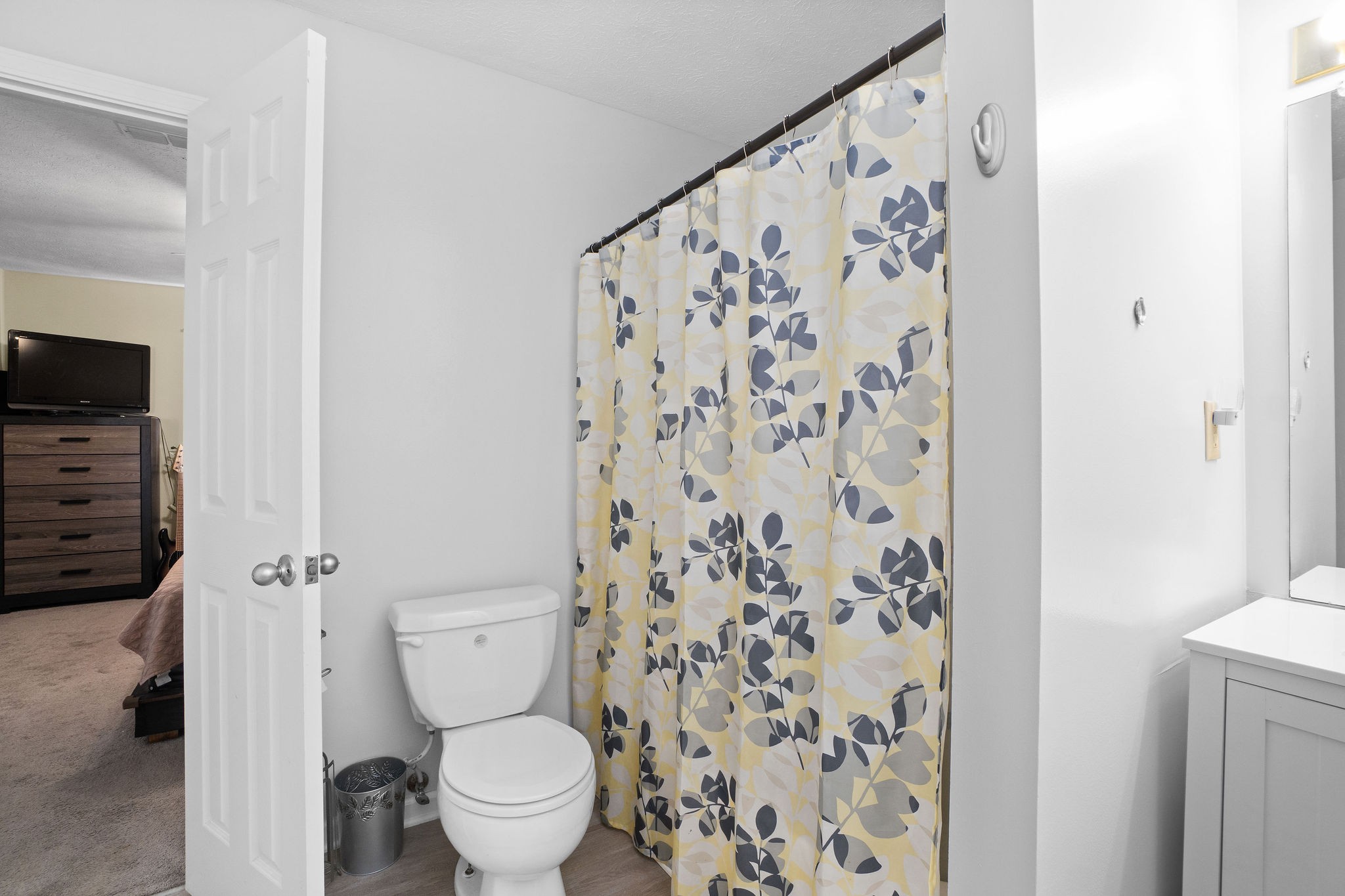 916 Hugh Hunter Road Oak Grove, KY 42262 - Photo 16 of 30 a white toilet sitting next to a shower curtain