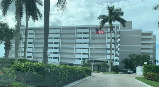 a front view of a multi story building with yard