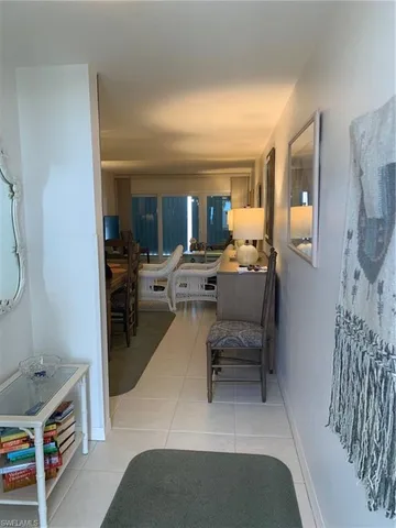 a living room with furniture a mirror and a table