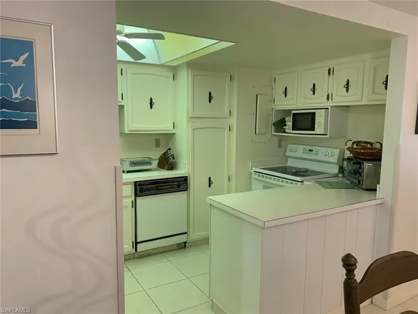 a kitchen with a refrigerator and a stove