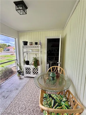a dining room with furniture and a floor to ceiling window