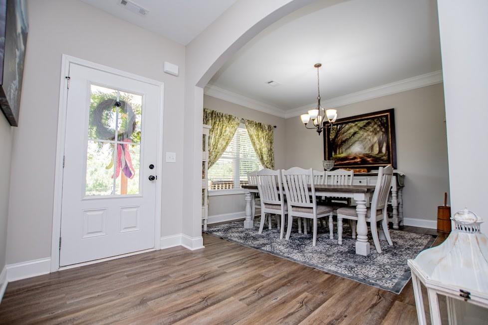 1851 McGarity Road Temple, GA 30179 - Photo 11 of 94 a dining room with wooden floor a chandelier a wooden table and chairs