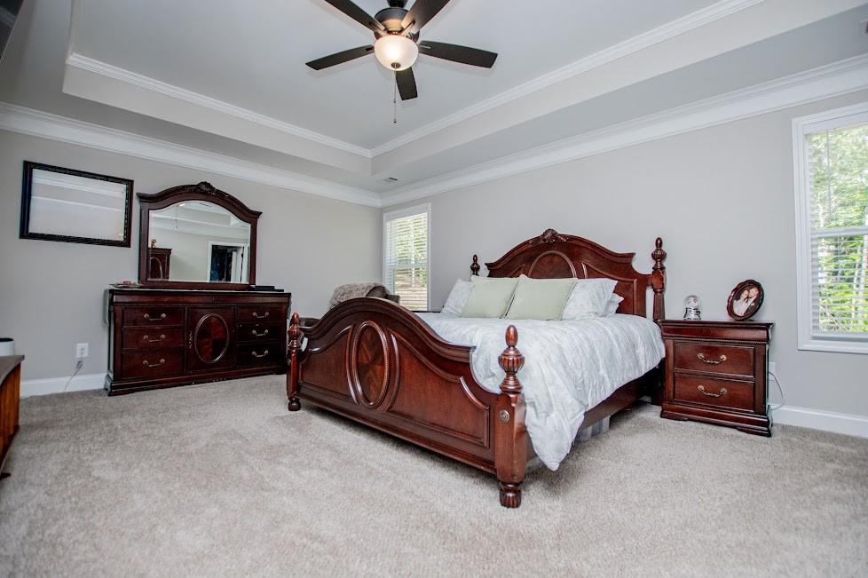 1851 McGarity Road Temple, GA 30179 - Photo 24 of 94 a spacious bedroom with a bed and a chandelier