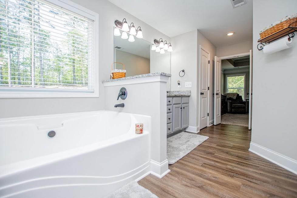 1851 McGarity Road Temple, GA 30179 - Photo 28 of 94 a bathroom with a tub a sink and a window