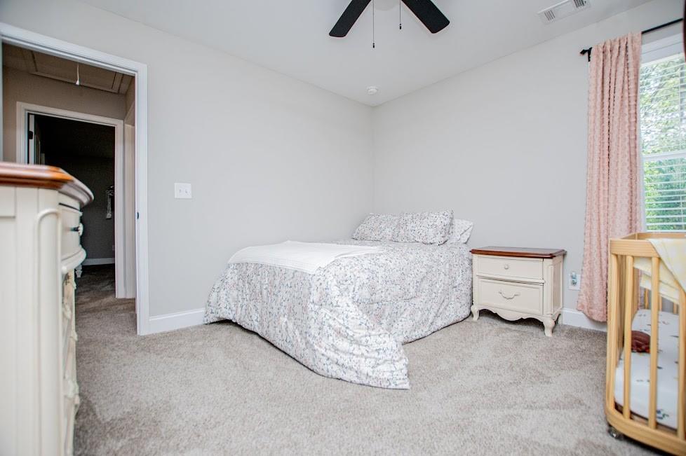 1851 McGarity Road Temple, GA 30179 - Photo 36 of 94 a bedroom with a bed and a chandelier