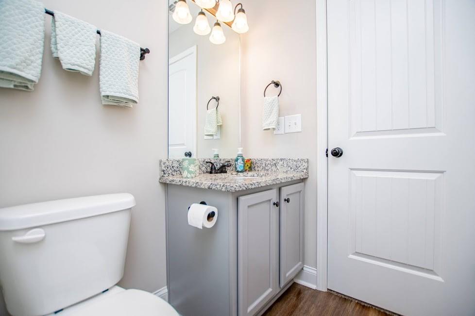 1851 McGarity Road Temple, GA 30179 - Photo 40 of 94 a bathroom with a granite countertop sink a toilet and a mirror