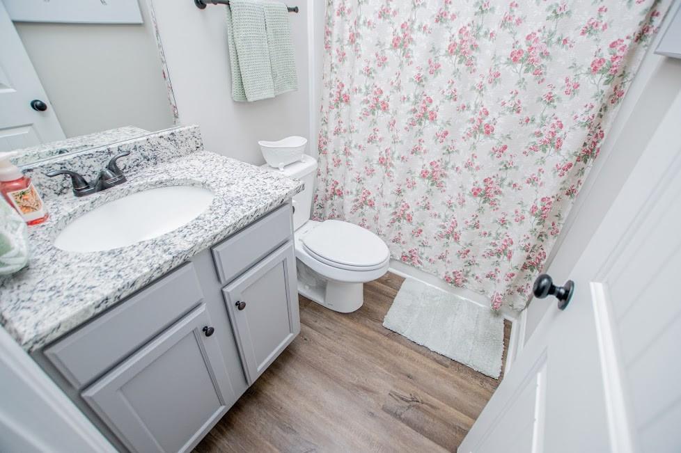 1851 McGarity Road Temple, GA 30179 - Photo 50 of 94 a bathroom with a granite countertop sink a toilet and a mirror