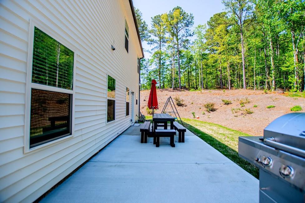1851 McGarity Road Temple, GA 30179 - Photo 69 of 94 a view of a patio with a table and chairs under an umbrella