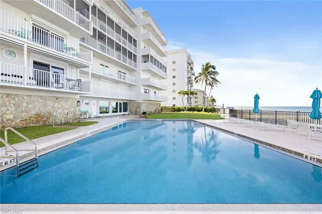 a swimming pool with outdoor seating and yard
