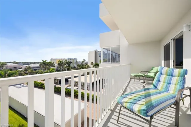 a view of a balcony with furniture