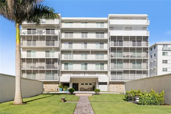 a front view of a building with a garden