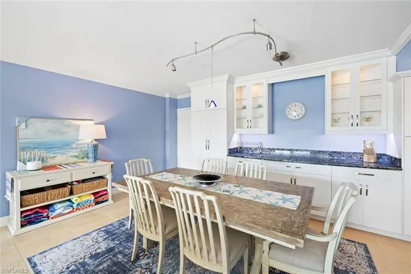 a view of a kitchen area with furniture and wooden floor