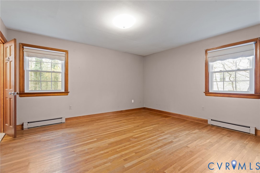 9440 Deerpark Court Midlothian, VA 23112 - Photo 20 of 55 an empty room with wooden floor and windows