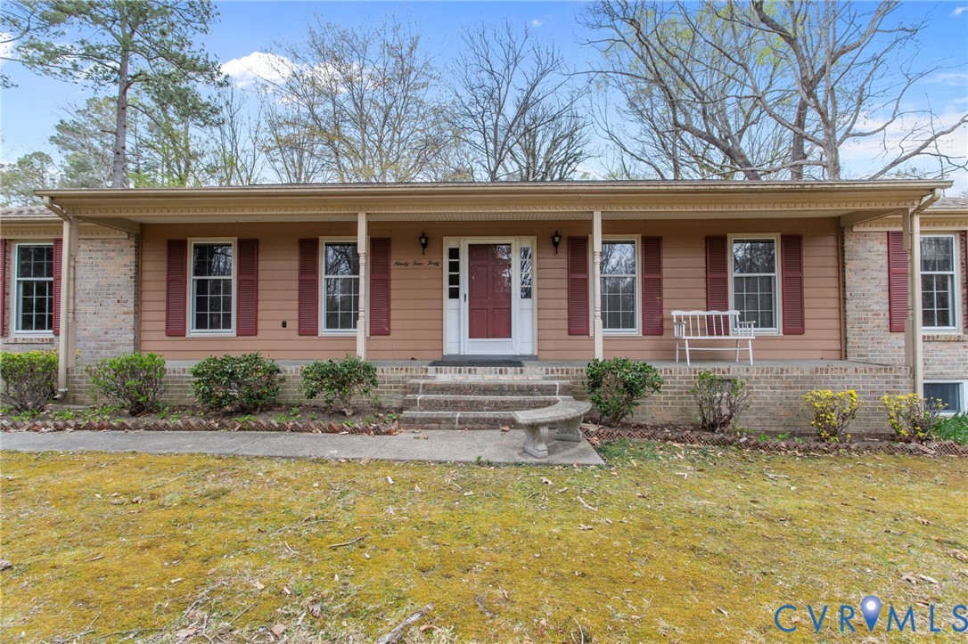 9440 Deerpark Court Midlothian, VA 23112 - Photo 2 of 55 a front view of a house with garden