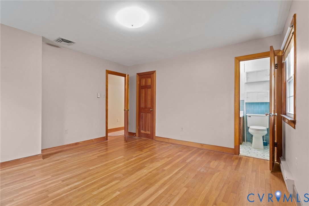 9440 Deerpark Court Midlothian, VA 23112 - Photo 22 of 55 a view of an empty room with wooden floor and a window