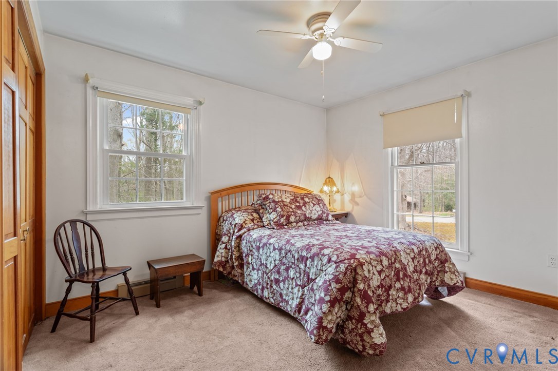 9440 Deerpark Court Midlothian, VA 23112 - Photo 24 of 55 a bedroom with a bed chair and a window
