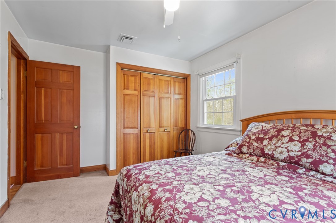 9440 Deerpark Court Midlothian, VA 23112 - Photo 25 of 55 a bedroom with a bed and a window