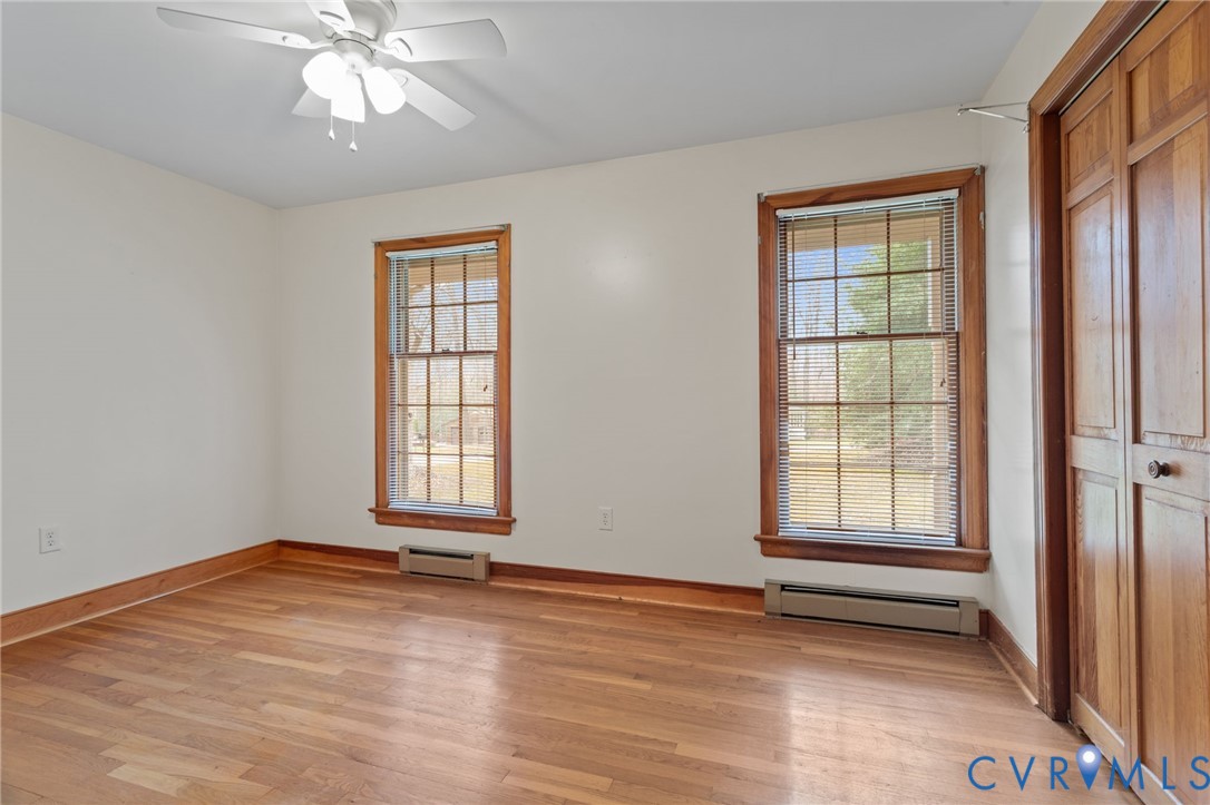 9440 Deerpark Court Midlothian, VA 23112 - Photo 26 of 55 an empty room with wooden floor chandelier fan and windows