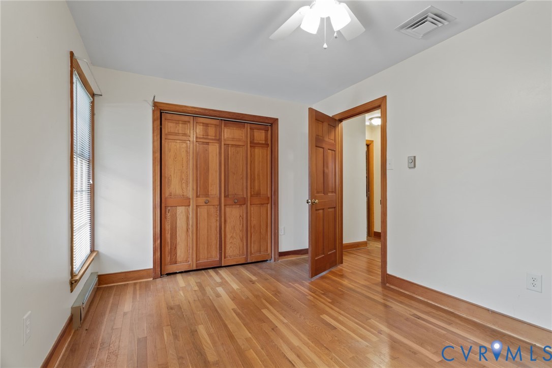 9440 Deerpark Court Midlothian, VA 23112 - Photo 27 of 55 a view of an empty room with wooden floor and a window