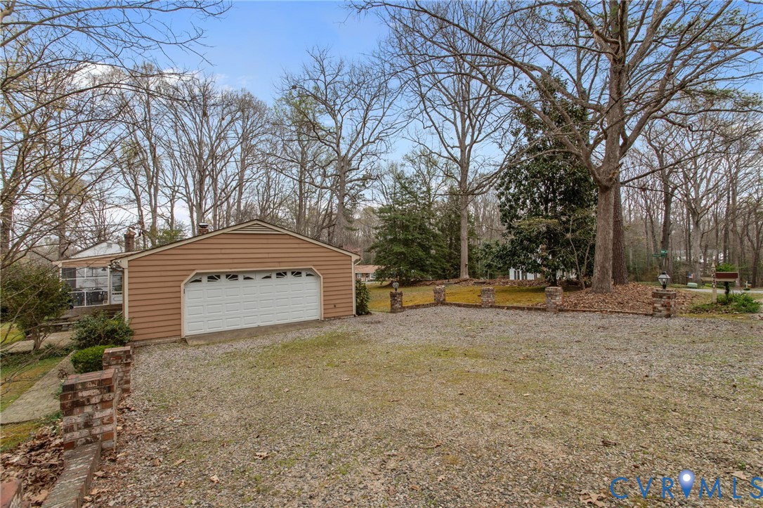 9440 Deerpark Court Midlothian, VA 23112 - Photo 52 of 55 a front view of a house with a yard and garage
